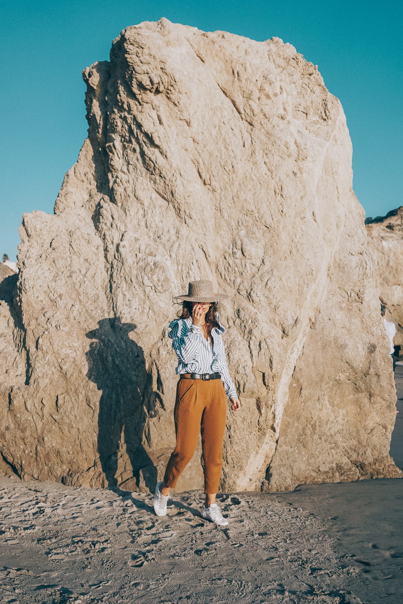 stripped_blouse-camel_trousers-lack_of_color_hat-wanderlust_jewels-matador_beach-malibu-golden_goose_sneakers-street_style-collage_vintage-159